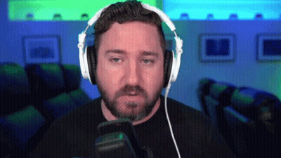 A Man With A Beard Is Wearing Headphones And A Microphone GIF