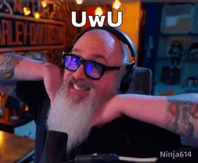 A Man With A Beard Is Wearing Headphones And Glasses And Has The Word Uwu On His Face GIF