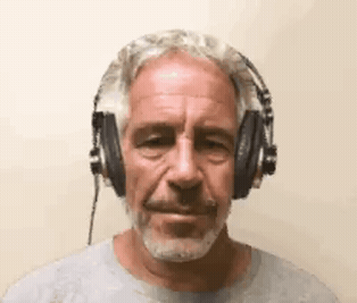 A Man With A Beard Is Wearing Headphones And Making A Funny Face . GIF