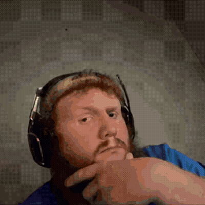 A Man With A Beard Is Wearing Headphones And Making A Funny Face GIF