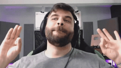 A Man With A Beard Is Wearing Headphones And Making An Ok Sign GIF