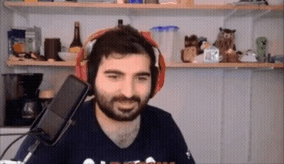 A Man With A Beard Is Wearing Headphones In Front Of A Microphone And Smiling GIF