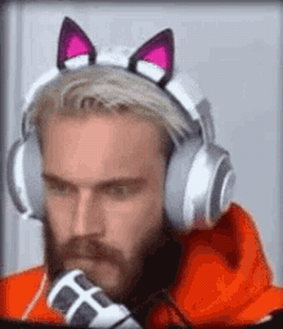 A Man With A Beard Is Wearing Headphones With Cat Ears On His Head . GIF