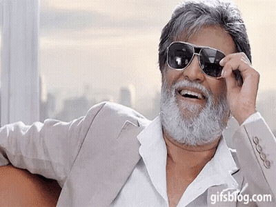 A Man With A Beard Is Wearing Sunglasses And A Gifsblog.com Watermark GIF