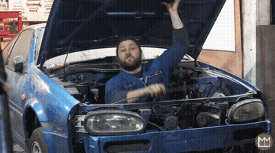 A Man With A Beard Is Working On A Blue Car GIF
