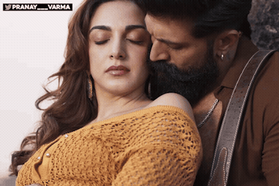 A Man With A Beard Kisses A Woman 'S Neck With The Words Pranay_varma Above Them GIF