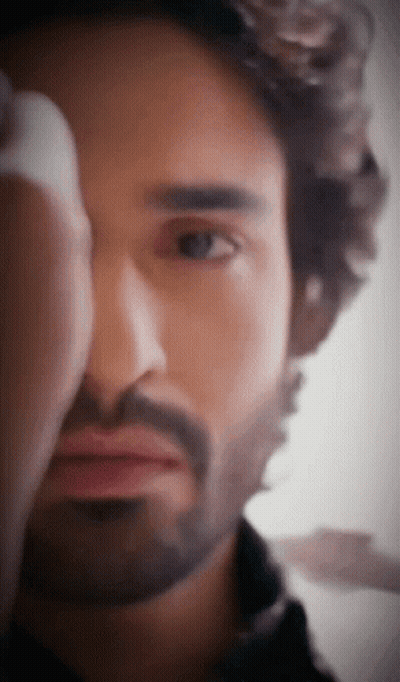 A Man With A Beard Looks At The Camera GIF