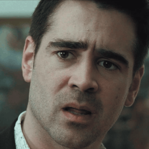 A Man With A Beard Looks At The Camera With A Serious Look On His Face GIF