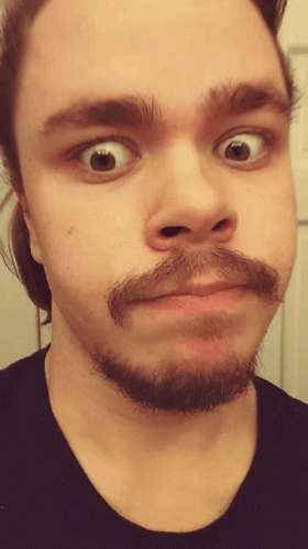 A Man With A Beard Makes A Funny Face GIF