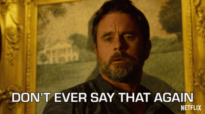 A Man With A Beard Says " Do N't Ever Say That Again " In Front Of A Painting GIF