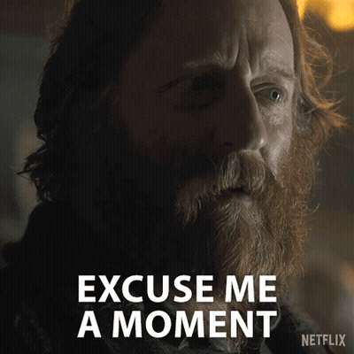 A Man With A Beard Says " Excuse Me A Moment " In A Netflix Ad GIF