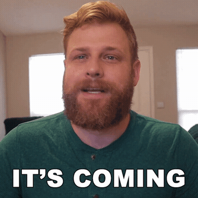 A Man With A Beard Says It 'S Coming In White Letters GIF