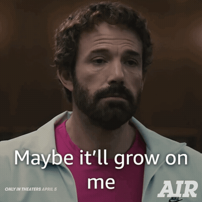 A Man With A Beard Says " Maybe It 'Ll Grow On Me " While Wearing A Pink Shirt GIF