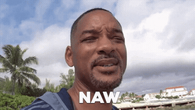 A Man With A Beard Says Naw In Front Of A Beach GIF
