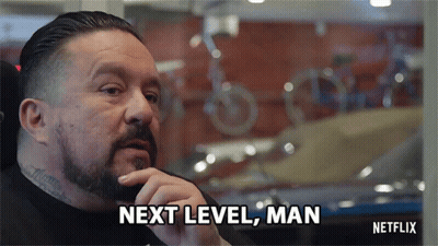 A Man With A Beard Says Next Level Man In Front Of A Window GIF