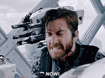 A Man With A Beard Says Now In Front Of A Robot GIF