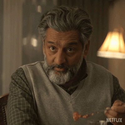 A Man With A Beard Says Please Tell Us More In A Netflix Ad GIF
