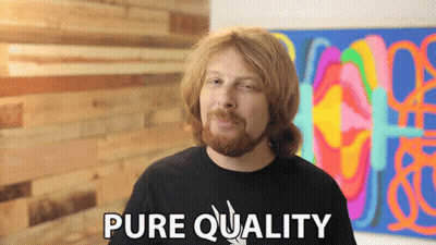 A Man With A Beard Says Pure Quality In Front Of A Painting GIF