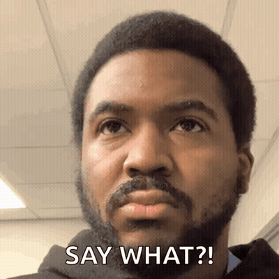 A Man With A Beard Says " Say What " In Front Of His Face GIF