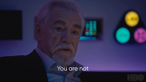 A Man With A Beard Says Serious People In Front Of A Purple Background GIF