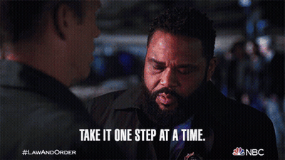 A Man With A Beard Says Take It One Step At A Time While Talking To Another Man GIF