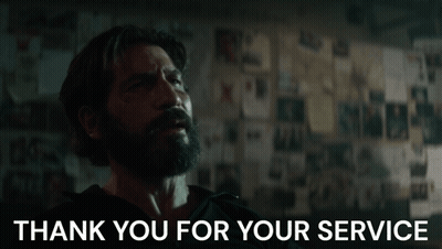 A Man With A Beard Says Thank You For Your Service In Front Of A Wall GIF