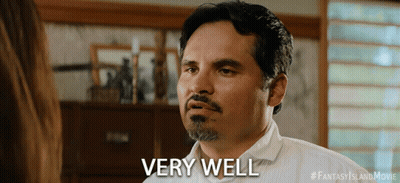 A Man With A Beard Says Very Well In Front Of A Woman GIF