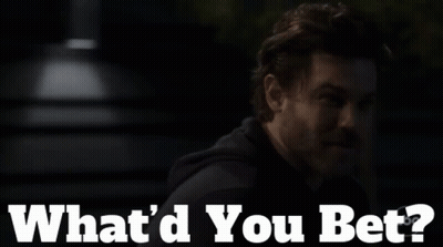 A Man With A Beard Says " What 'D You Bet " In A Dark Room GIF