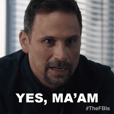 A Man With A Beard Says " Yes Ma 'Am " In Front Of A Window GIF