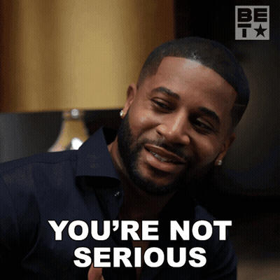 A Man With A Beard Says You 'Re Not Serious In Front Of A Lamp GIF