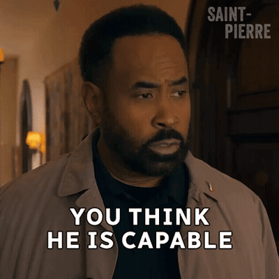 A Man With A Beard Says " You Think He Is Capable " In Front Of A Door GIF