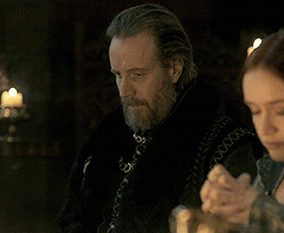 A Man With A Beard Sits At A Table With A Woman GIF