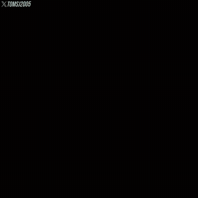 A Man With A Beard Sits In A Grassy Field With Toms 2005 Written On The Bottom Right GIF
