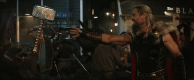 A Man With A Beard Stands In Front Of A Crowd Of People GIF