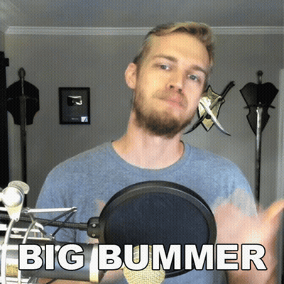 A Man With A Beard Stands In Front Of A Microphone With The Words Big Bummer Below Him GIF