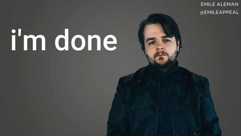 A Man With A Beard Stands In Front Of A Sign That Says I 'M Done GIF