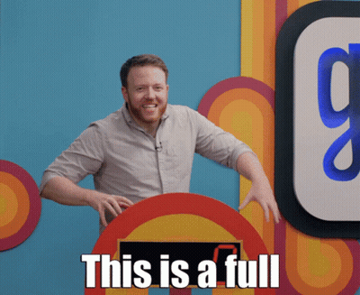 A Man With A Beard Stands In Front Of A Sign That Says " This Is A Full " GIF