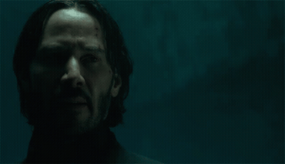 A Man With A Beard Stands In Front Of A Sign That Says " Yeah " GIF