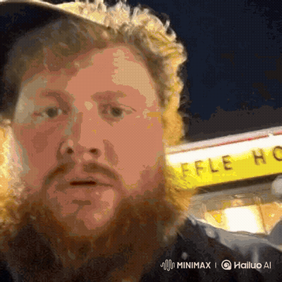 A Man With A Beard Stands In Front Of A Waffle House Sign GIF