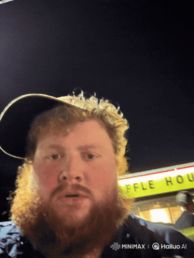 A Man With A Beard Stands In Front Of A Waffle House Sign GIF
