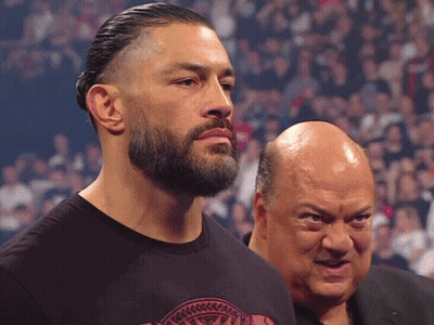 A Man With A Beard Stands Next To Another Man GIF