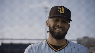 A Man With A Beard Wearing A Baseball Cap And Smiling . GIF