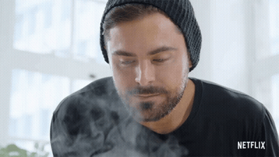 A Man With A Beard Wearing A Beanie And A Black Shirt With Netflix Written On The Bottom GIF