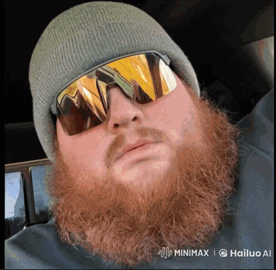 A Man With A Beard Wearing A Beanie And Sunglasses Has A Watermark That Says Hailuo Ai GIF