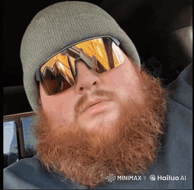 A Man With A Beard Wearing A Beanie And Sunglasses Has A Watermark That Says Hailuo Ai GIF