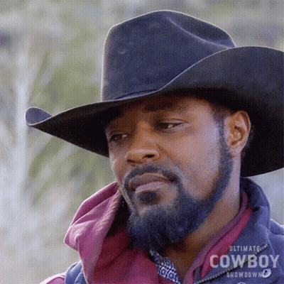 A Man With A Beard Wearing A Black Cowboy Hat GIF