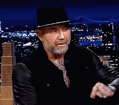 A Man With A Beard Wearing A Black Hat And A Leather Jacket GIF