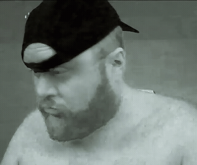A Man With A Beard Wearing A Black Hat GIF