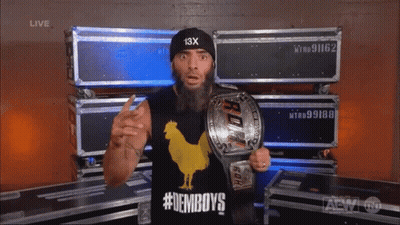 A Man With A Beard Wearing A Black Hat With 13X On It GIF