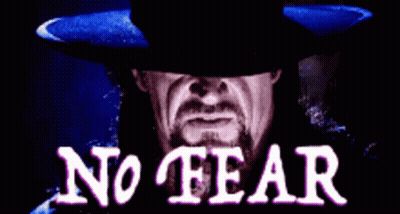 A Man With A Beard Wearing A Black Hat With The Words No Fear Written On It GIF